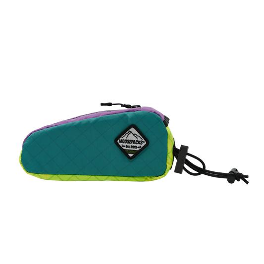 Teal, lilac, HiVis, aerodynamic MoosePacks bolt-on bike storage pack with plastic bottom insert and protective bolt cover.